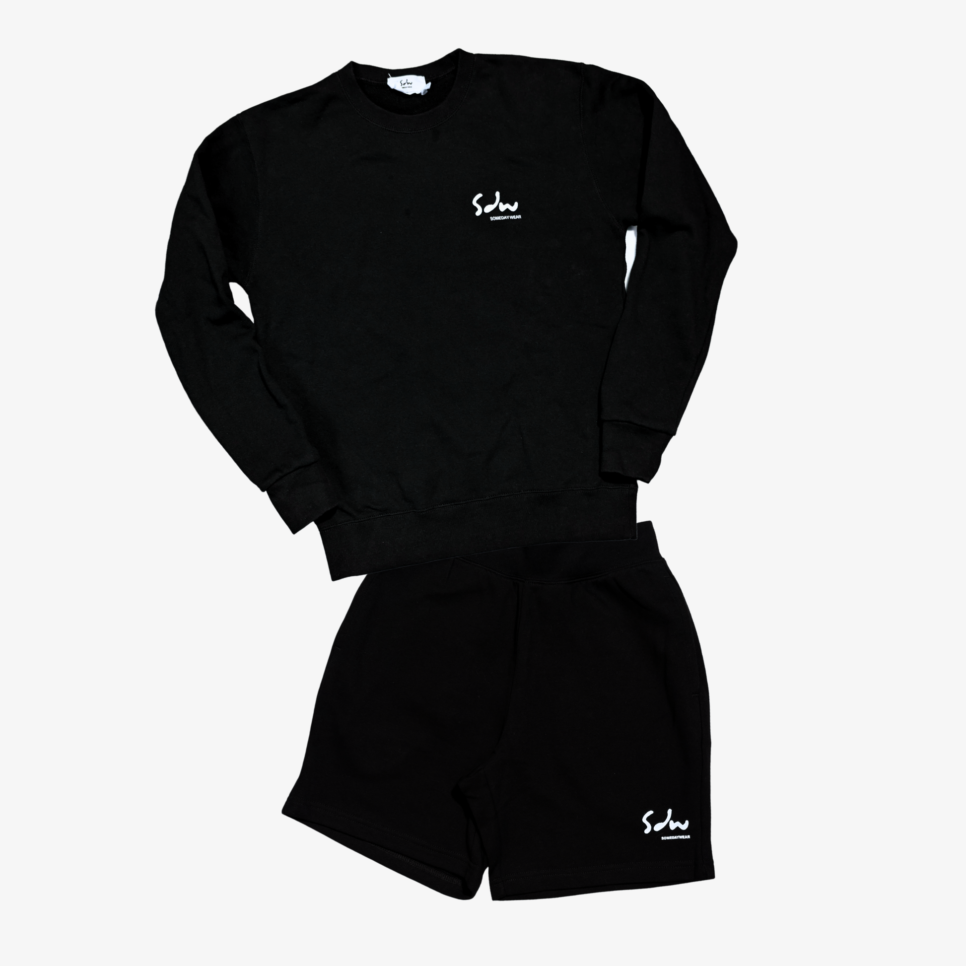 Black sweatshirt & shorts set made from midweight cotton. They are soft, breathable, and easy to wear across different settings. Comfortable enough for long days, without feeling too light or flimsy.